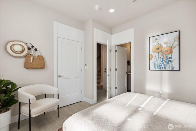 13362 NE 143rd Ct Unit 53, Woodinville, WA 98072 - bedroom with baseboards, light wood-style floors, and recessed lighting