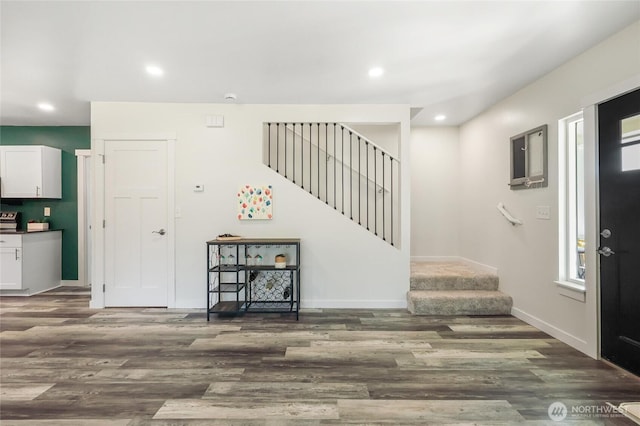 entrance foyer featuring a wealth of natural light, wood finished floors, recessed lighting, and stairway
