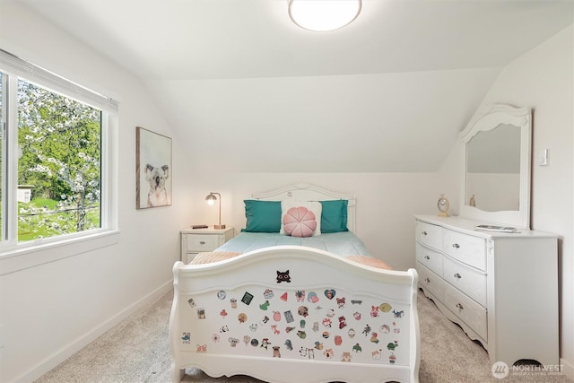 bedroom featuring baseboards, vaulted ceiling, and light colored carpet