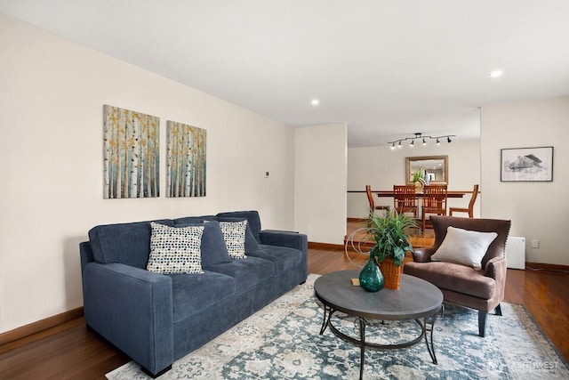 living room featuring track lighting, baseboards, recessed lighting, and wood finished floors