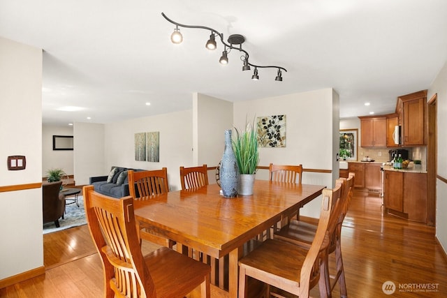 dining room featuring recessed lighting, baseboards, and light wood finished floors