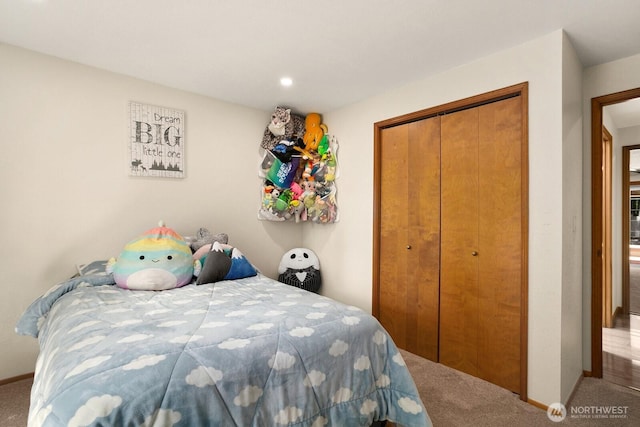 bedroom featuring a closet, carpet, and baseboards