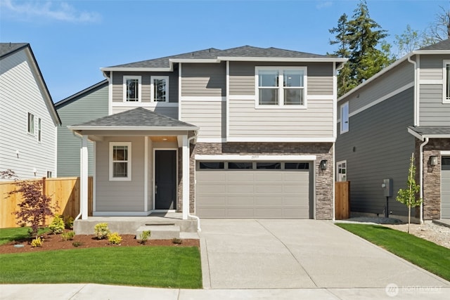 20519 97th Ave E Unit 26, Graham, WA 98338 - view of front facade featuring stone siding, concrete driveway, an attached garage, covered porch, and roof with shingles