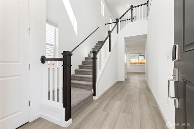 20519 97th Ave E Unit 26, Graham, WA 98338 - foyer entrance with light wood-type flooring, stairway, and baseboards
