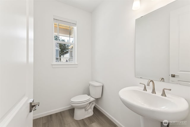 20519 97th Ave E Unit 26, Graham, WA 98338 - bathroom featuring wood finished floors, a sink, baseboards, and toilet