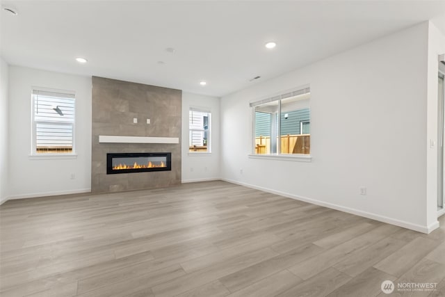 20519 97th Ave E Unit 26, Graham, WA 98338 - unfurnished living room with a fireplace, light wood-style floors, baseboards, and recessed lighting