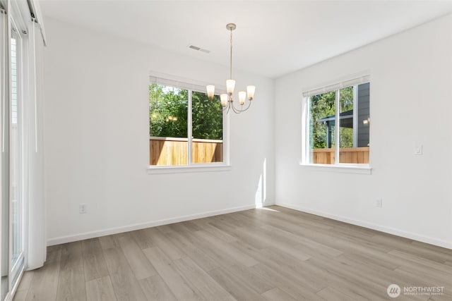 20519 97th Ave E Unit 26, Graham, WA 98338 - spare room with wood finished floors, a chandelier, and baseboards