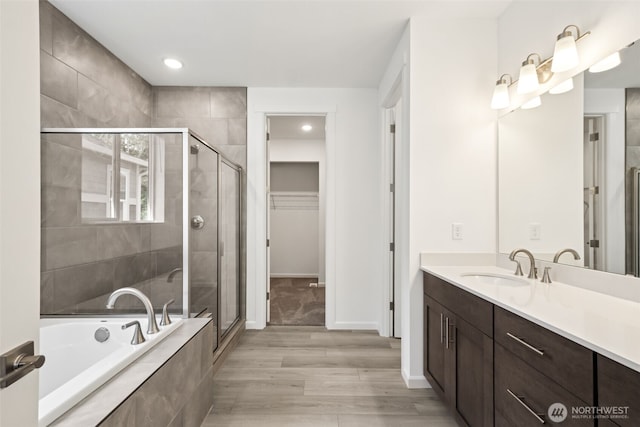 20519 97th Ave E Unit 26, Graham, WA 98338 - bathroom featuring a shower stall, vanity, a garden tub, a walk in closet, and recessed lighting