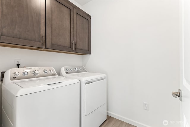20519 97th Ave E Unit 26, Graham, WA 98338 - washroom featuring cabinet space, washer and dryer, light wood-style floors, and baseboards