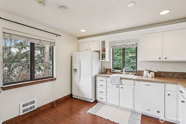 300 N 137th St Unit C, Seattle, WA 98133 - kitchen with white appliances, dark wood-style flooring, white cabinetry, and recessed lighting