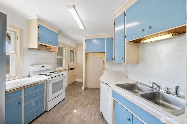 kitchen featuring light countertops, a sink, blue cabinets, and white appliances