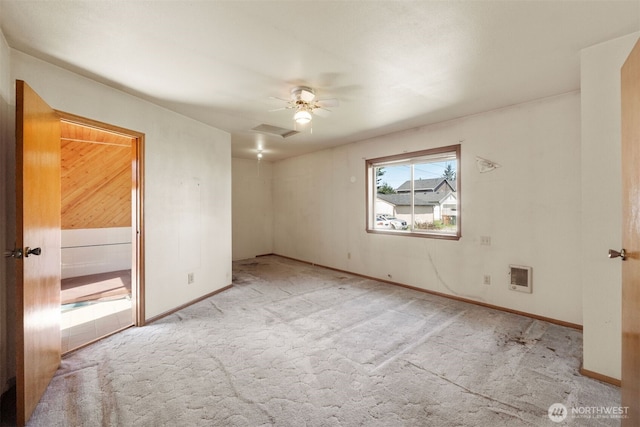 spare room with visible vents, a ceiling fan, baseboards, attic access, and light colored carpet
