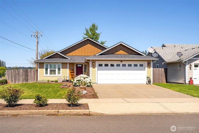 101 Holloway Dr, Chehalis, WA 98532 - view of front of home featuring fence, an attached garage, driveway, a front yard, and board and batten siding