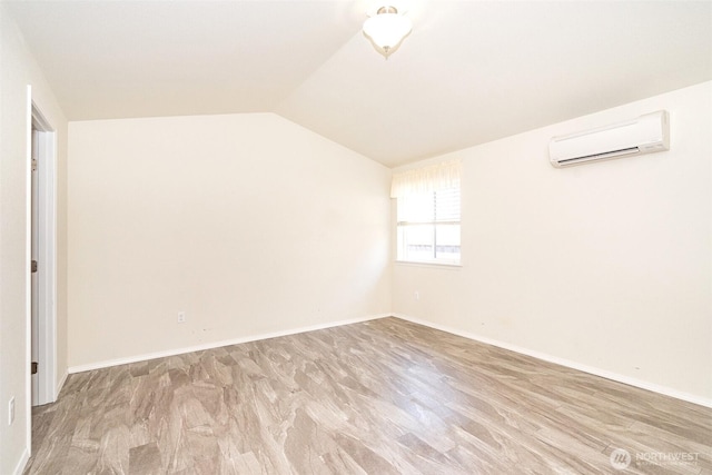 101 Holloway Dr, Chehalis, WA 98532 - unfurnished room featuring vaulted ceiling, an AC wall unit, and baseboards