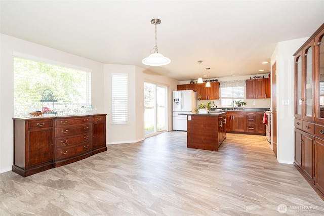 101 Holloway Dr, Chehalis, WA 98532 - kitchen with a sink, freestanding refrigerator, pendant lighting, baseboards, and a kitchen island