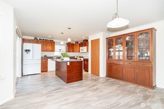 101 Holloway Dr, Chehalis, WA 98532 - kitchen featuring recessed lighting, brown cabinetry, white appliances, hanging light fixtures, and a kitchen island
