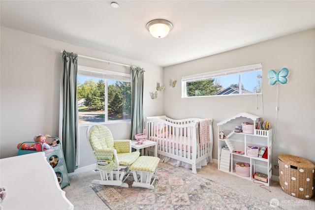 carpeted bedroom featuring a crib