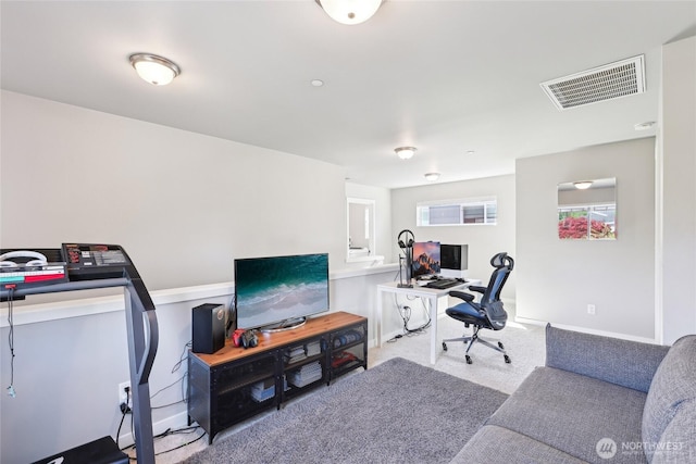 office space featuring baseboards, visible vents, and carpet floors