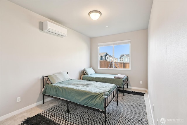 carpeted bedroom with a wall mounted air conditioner and baseboards
