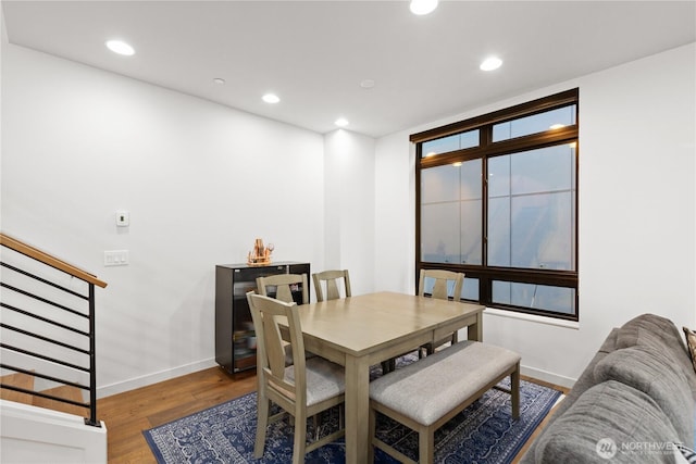 dining room featuring recessed lighting, stairway, baseboards, and wood finished floors