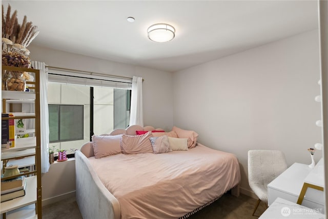 carpeted bedroom with baseboards
