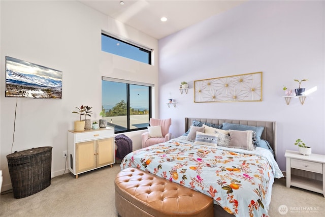 bedroom featuring recessed lighting, light colored carpet, and a towering ceiling