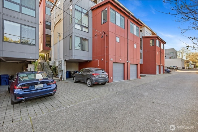 view of building exterior featuring a garage and aphalt driveway