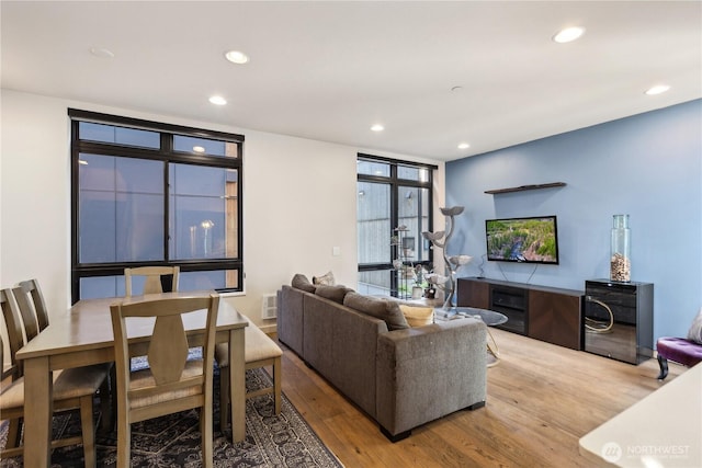 living room featuring wood finished floors, visible vents, and recessed lighting