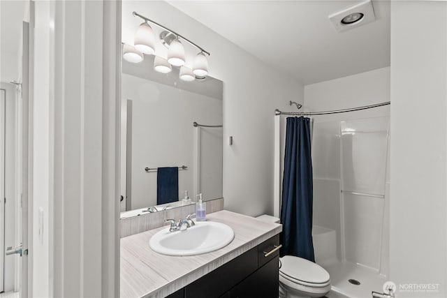 full bathroom with vanity, a shower with shower curtain, and toilet