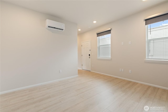 13509 197th St E, Graham, WA 98338 - unfurnished room with a wall mounted air conditioner, light wood finished floors, plenty of natural light, baseboards, and recessed lighting
