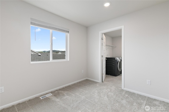 13509 197th St E, Graham, WA 98338 - unfurnished bedroom featuring washing machine and dryer, carpet, a spacious closet, baseboards, and a closet