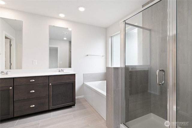 13509 197th St E, Graham, WA 98338 - bathroom featuring double vanity, a bath, a stall shower, and recessed lighting