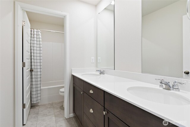 13509 197th St E, Graham, WA 98338 - full bath with toilet, double vanity, shower / bath combo with shower curtain, and tile patterned flooring