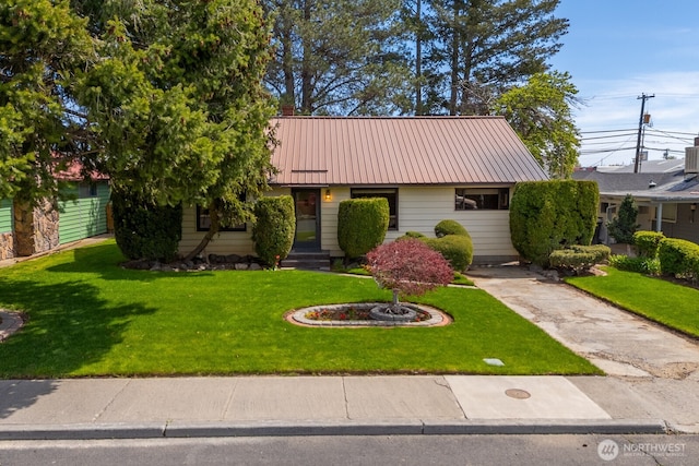 view of front of property with a front lawn and metal roof