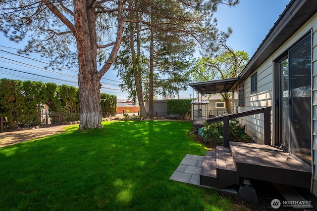 view of yard with fence and a deck