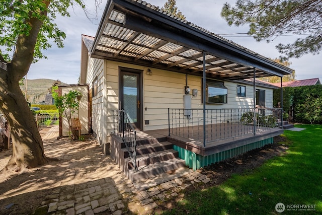 back of house with a deck