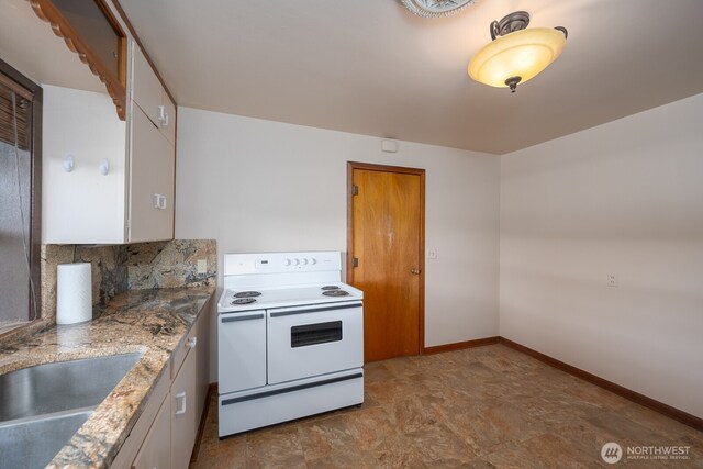 kitchen with a sink, electric range, backsplash, white cabinetry, and light countertops