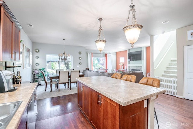 kitchen featuring light countertops, dark wood-style flooring, a sink, and a wealth of natural light