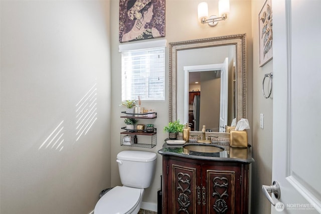 bathroom featuring vanity and toilet