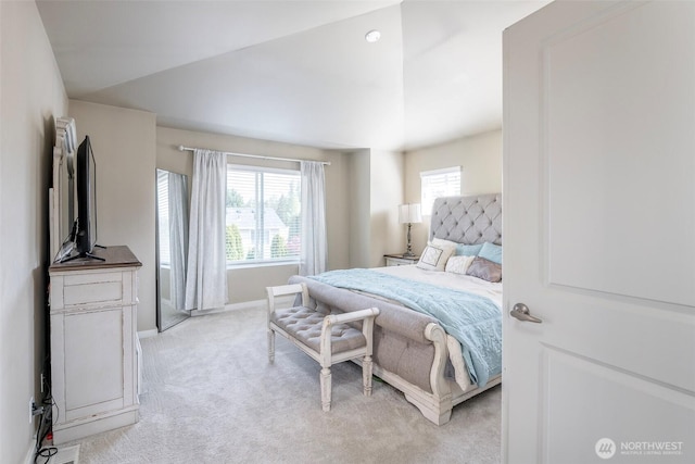 bedroom featuring baseboards, light colored carpet, and vaulted ceiling