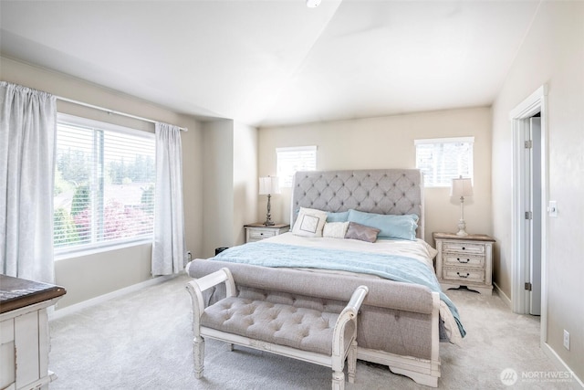 bedroom with light colored carpet and baseboards