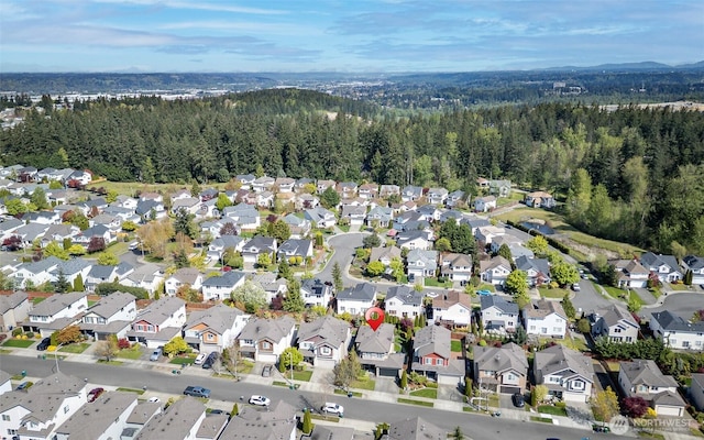 drone / aerial view with a residential view and a forest view