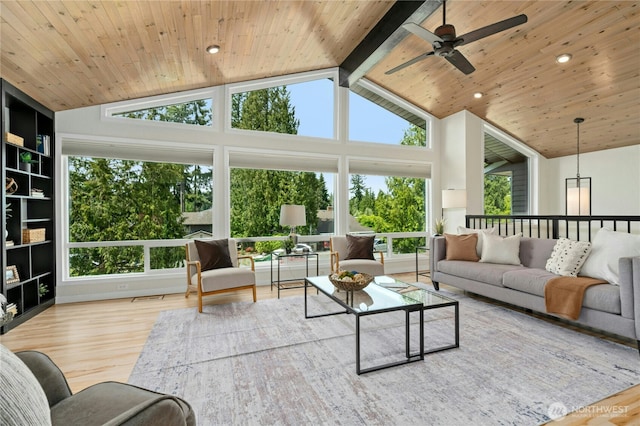 sunroom featuring plenty of natural light and lofted ceiling