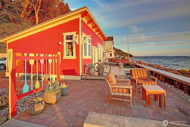 patio terrace at dusk with a water view