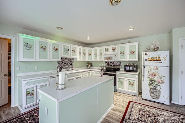 29685 129th Pl SE, Auburn, WA 98092 - kitchen with light wood finished floors, a sink, white appliances, light countertops, and white cabinets