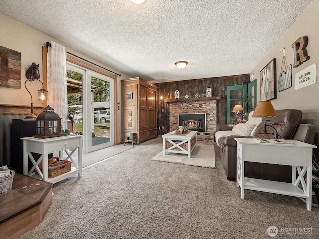 27709 293rd Ave SE, Ravensdale, WA 98051 - living room featuring carpet floors, a textured ceiling, wooden walls, and a fireplace