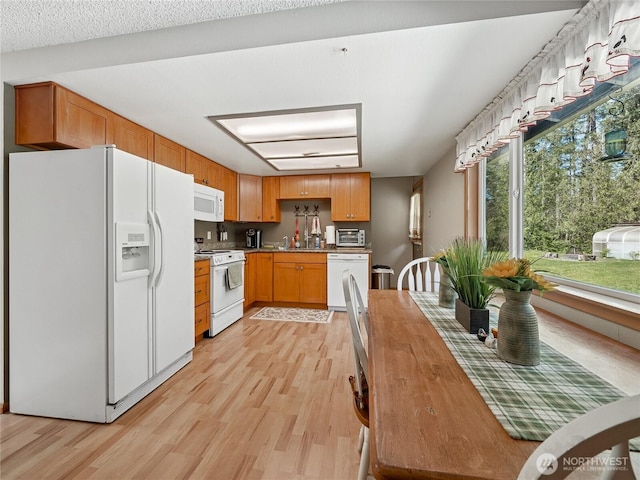 27709 293rd Ave SE, Ravensdale, WA 98051 - kitchen featuring white appliances and light wood-type flooring