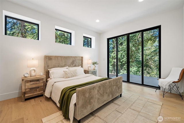 17720 SE 63rd Pl, Bellevue, WA 98006 - bedroom featuring access to outside, multiple windows, recessed lighting, and light wood-style floors