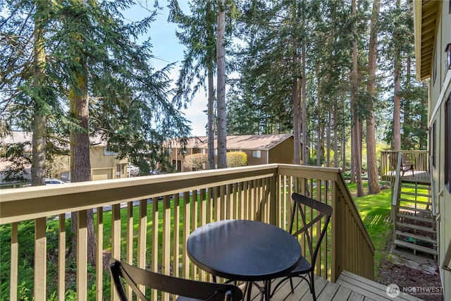 wooden terrace featuring a yard