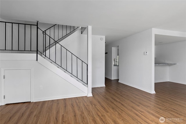 interior space featuring baseboards and wood finished floors